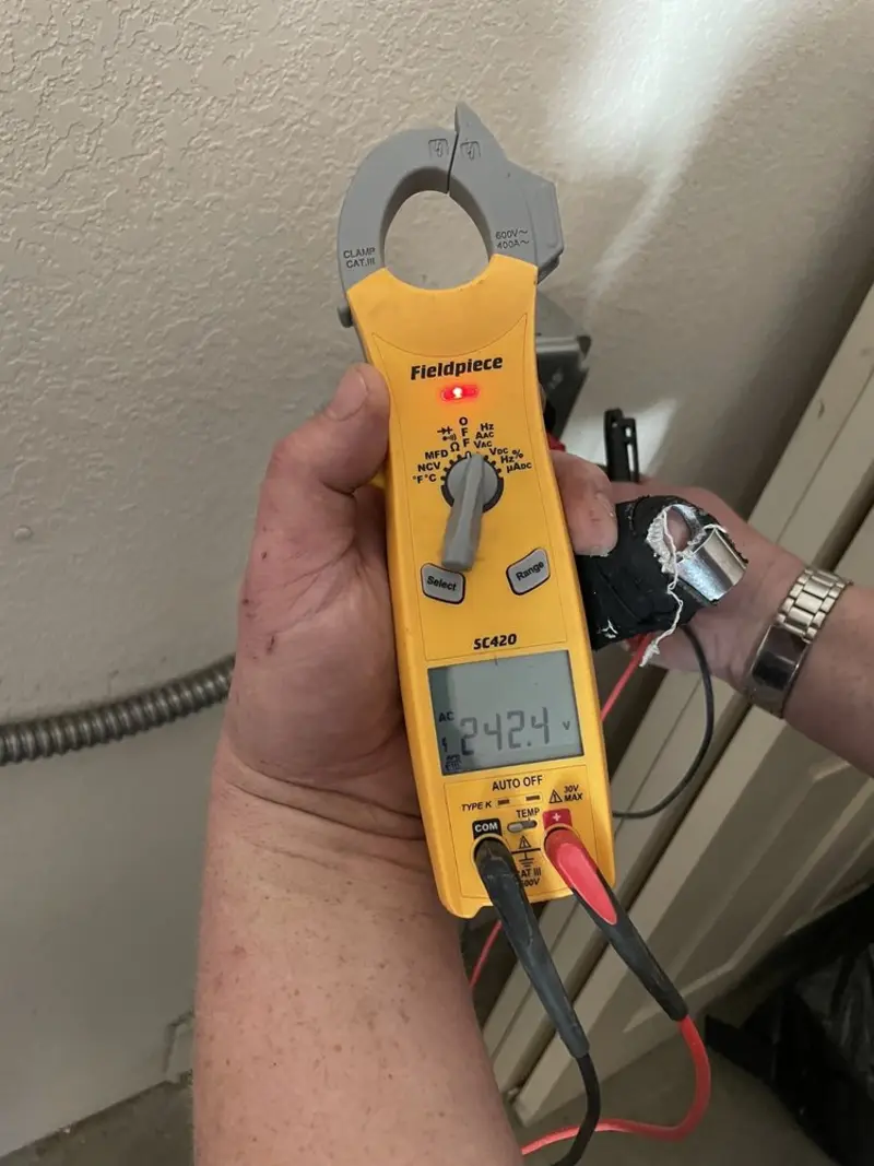 Voltage testing with clamp meter during Ceiling Fan Installation in McLean